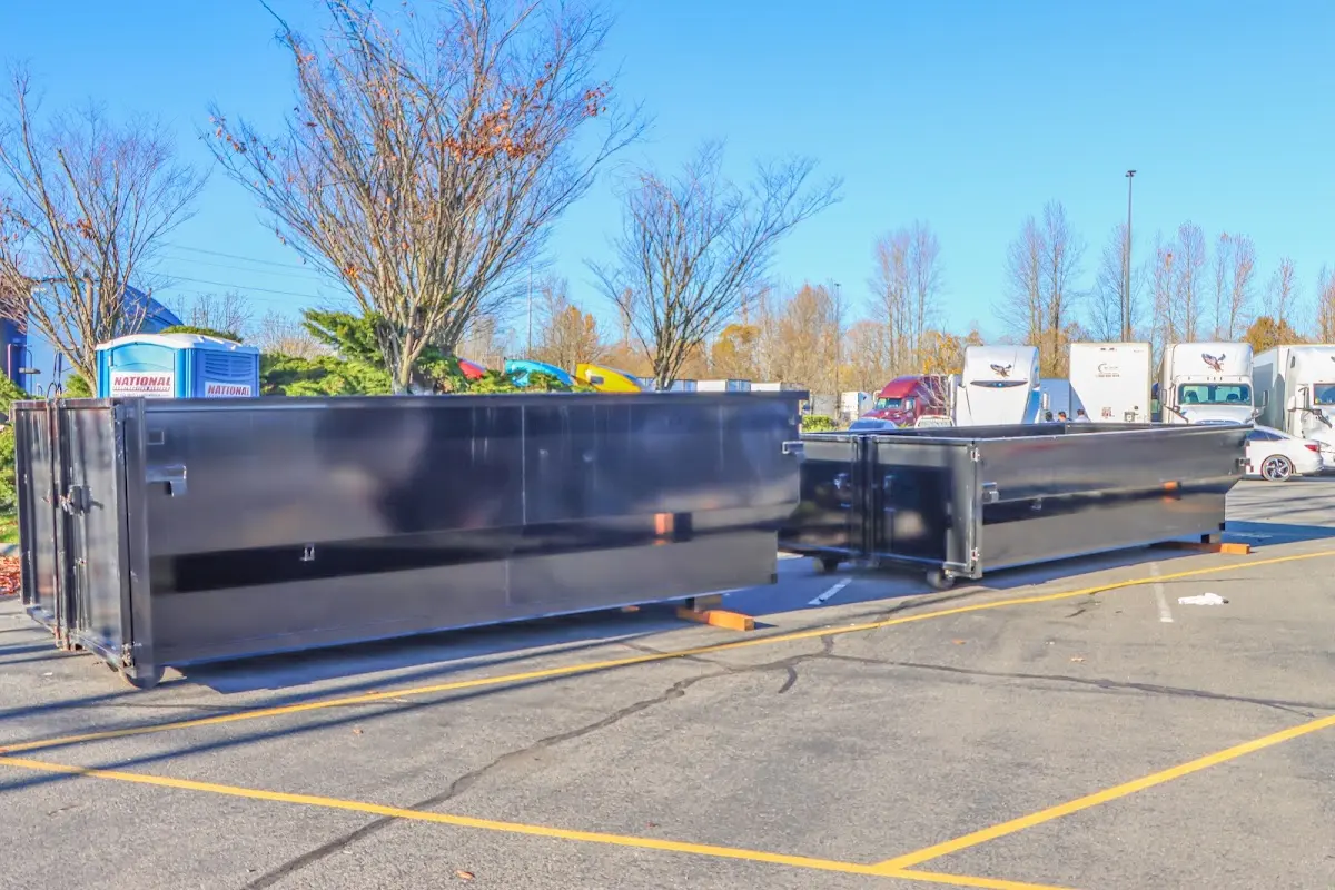 Professional dumpster rental service with roll-off container on residential driveway in Wappinger